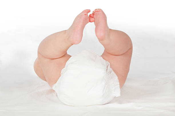 Cute baby buttock with diaper. Cute baby bum with diaper on white background. Cute soft baby, selected focus. pics of girls buttocks stock pictures, royalty-free photos & images
