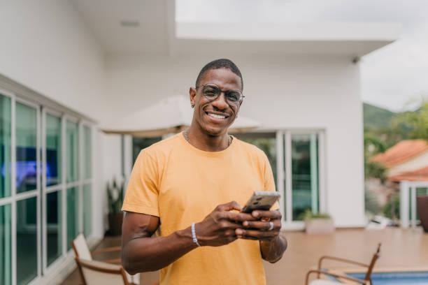 istock Smiling man holding smartphone in backyard 1790411240