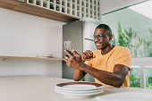 Man using smartphone in the kitchen