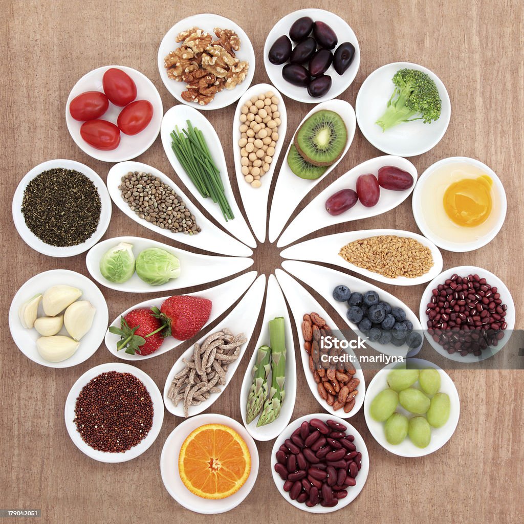 Health Food Platter Large health food selection in white porcelain bowls and dishes over papyrus background. Adzuki Bean Stock Photo
