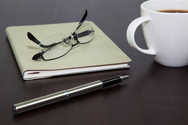 istock Cup of coffee on a wooden table with book 179042360