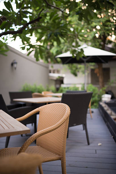 istock Dining wooden table with wicker chairs outdoors 179042535