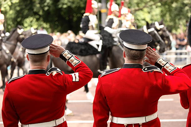istock Two British soldiers saluting at a royal parade 179043231