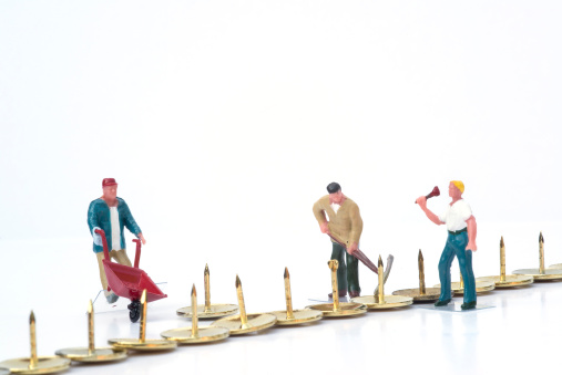 Miniature people teamwork overcoming obstacles business concept