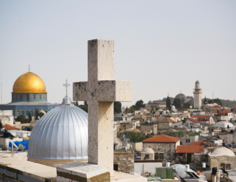 Cross, mosques, church and jerusalem old city sky