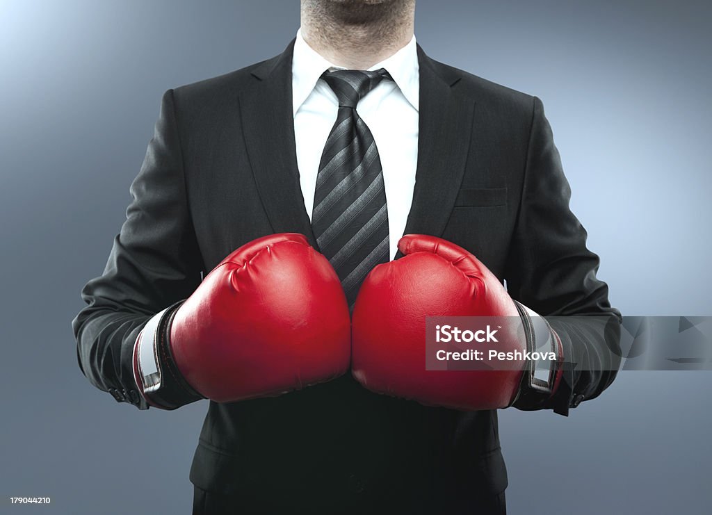 man in boxing gloves businessman in boxing gloves isolated on blue Adult Stock Photo man in boxing gloves businessman in boxing gloves isolated on blue Adult Stock Photo