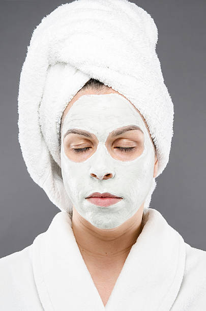 Relaxed Beauty Mask Image of a model relaxed with a facial women facial mask mud cucumber stock pictures, royalty-free photos & images