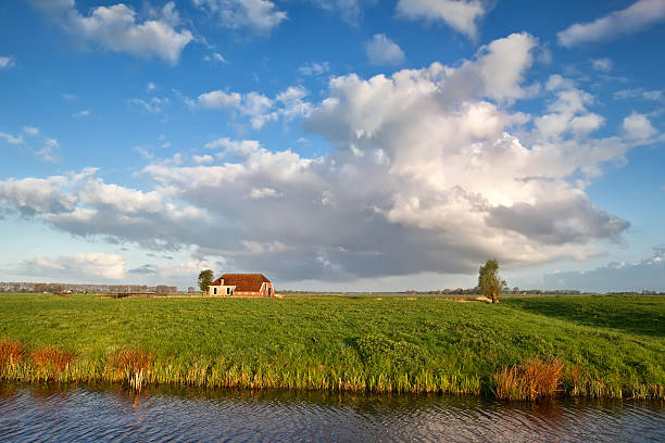 istock charming farmhouse and beautiful sky 179044472
