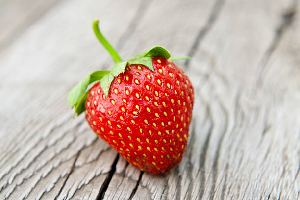 istock Ripe strawberry on wooden table 179045320