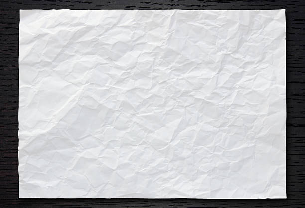 istock White crumpled paper on dark wood 179045850