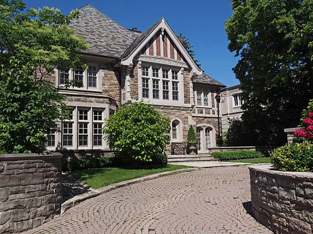 Tudor style stone house with circular drive