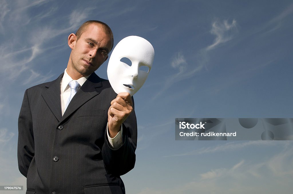 Man behind the mask Businessman contemplating whether to wear the mask Blue Stock Photo
