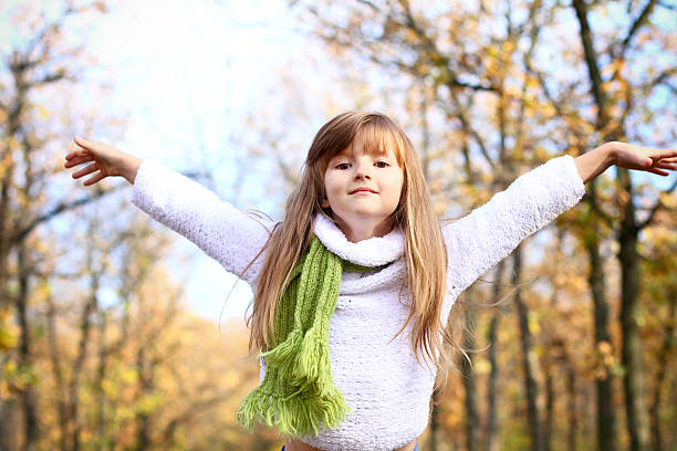 istock Little girl with hands up in autumn forest 179047830