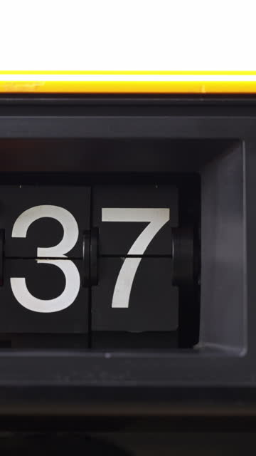 Flip clock tells the time from number 57 to stop number 37