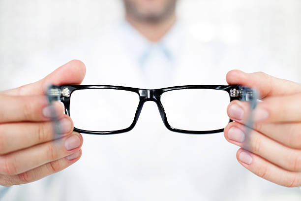 istock Closeup of optometrist, optician giving glasses 179048991