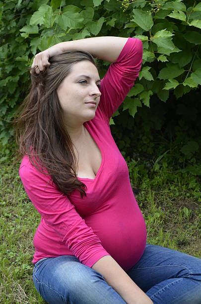 istock Pregnant woman is resting in the grass 179049453