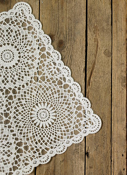 istock wooden background with white lace napkin 179049729