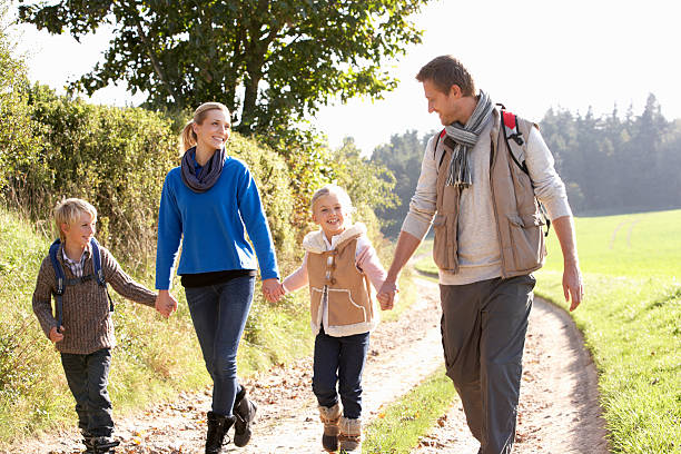istock Young family walking in park 179050440