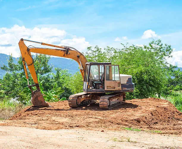 Excavator and Workers Working on Construction Site