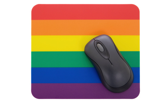 Wireless mouse on a mousepad with the iconic rainbow motif.
