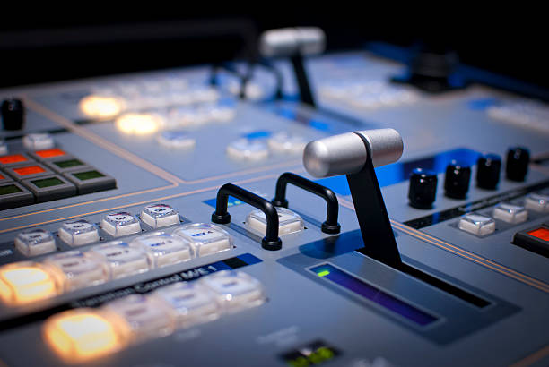 Detail of Video Production Switcher Board Video production switcher board for live video production. Depth of field focuses attention on center controls. interlace format stock pictures, royalty-free photos & images