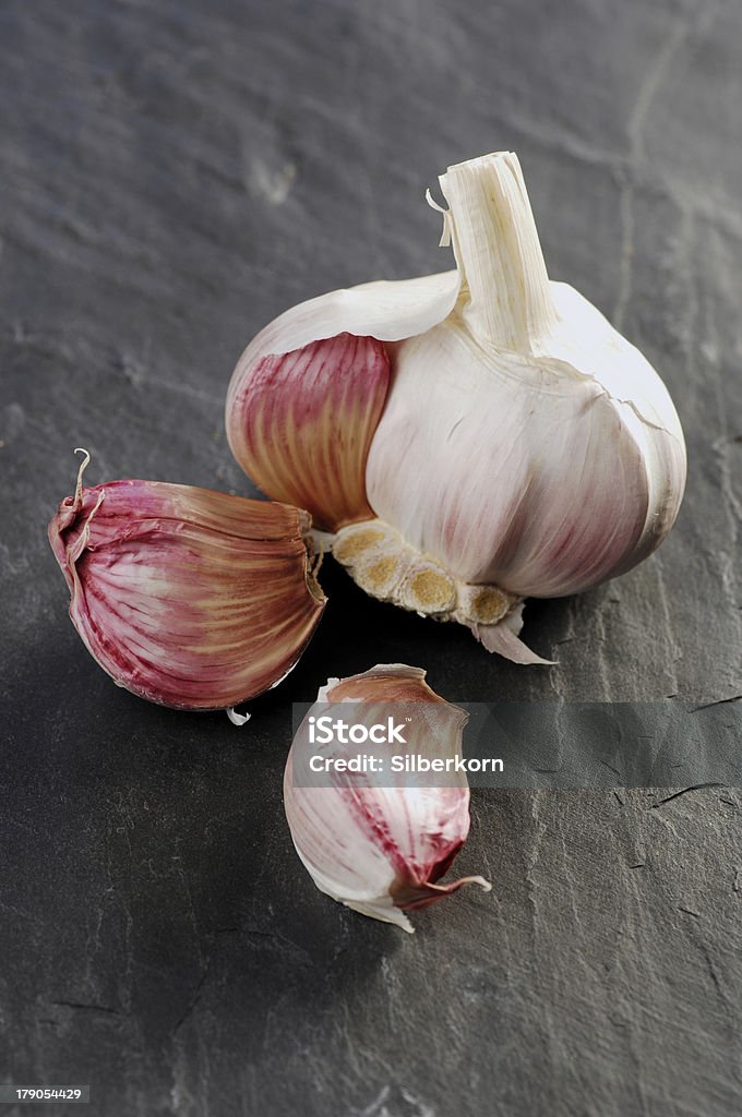 Garlic Garlic bulb and cloves on grey background Clove - Spice Stock Photo