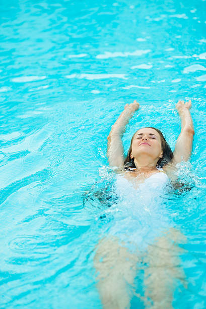 istock Young woman swimming in pool 179055661