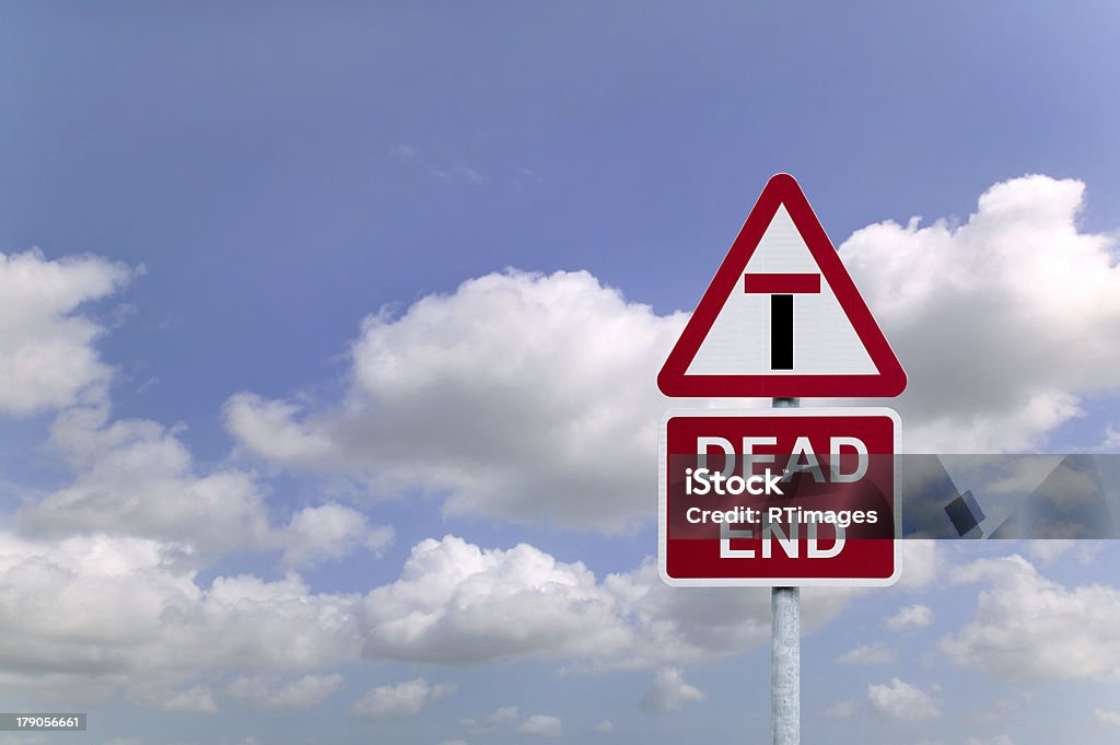 Dead End Concept image of a signpost for a Dead End against a blue cloudy sky. Business Stock Photo