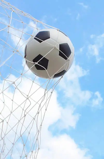 a soccer ball in a net with sky