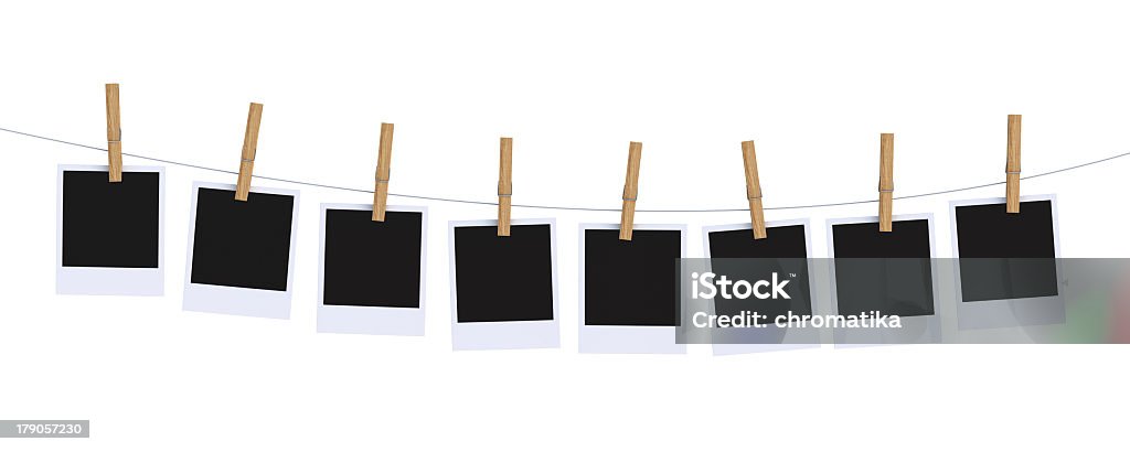 A row of Polaroid photos hanging with wooden pegs Eight black photos attached to a cable with clips on white background. Arts Culture and Entertainment Stock Photo