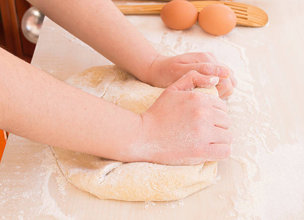 istock young woman kneading dough 179057342