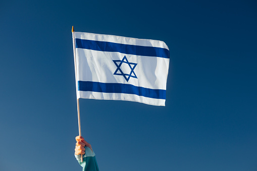 Cheerful enthusiastic patriotic person displaying the symbol of Israel