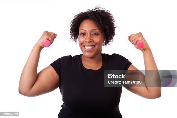 Overweight Black Woman Working Out With Pink Weights Stock Photo - Download Image Now