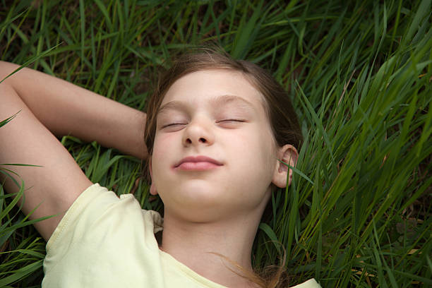 istock Girl relaxing on a meadow in nature 179059036