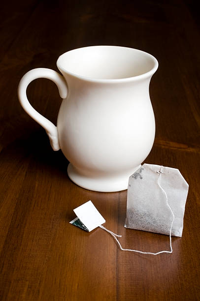 istock Tea Cup and Bag on wooden table surface 179059224