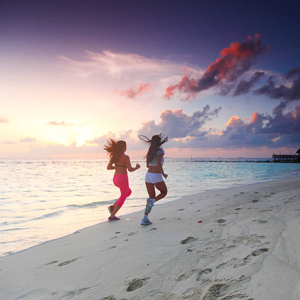 istock Two women running on beach 179059303