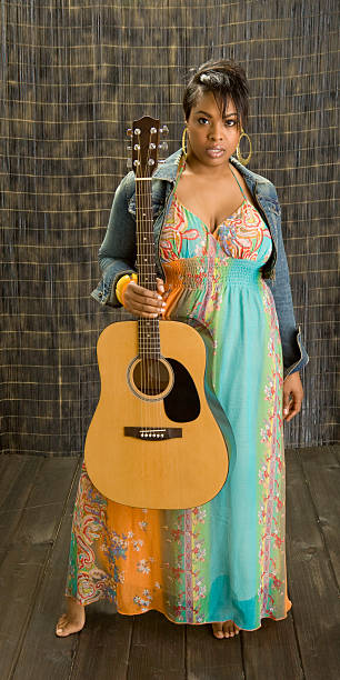 istock Black Female Musician Holds Her Guitar 179059457