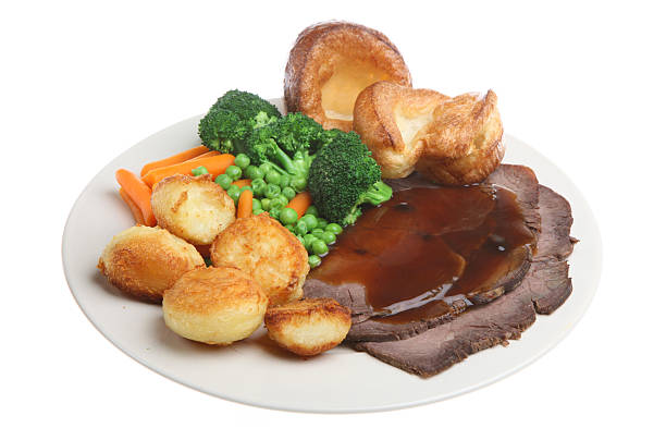istock Roast beef dinner with Yorkshire puddings, potatoes and veg 179059608