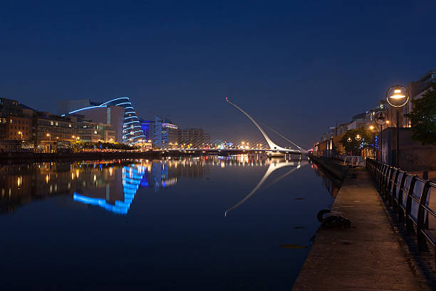 rio liffey com samuel beckett bridge ao fundo - dublin ireland samuel beckett bridge bridge night - fotografias e filmes do acervo