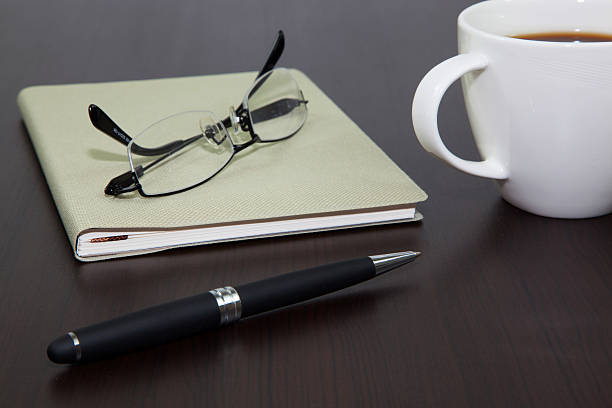 istock Cup of coffee on a wooden table with book 179060113