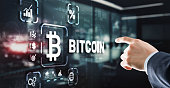 Hand touching Bitcoin button. Modern business technology concept. Bitcoin, Ethereum