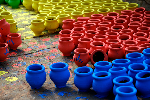07 November 2023, Pune, India, An Potter applies colour to earthenware oil pots or diyas at a workshop, ahead of the forthcoming Diwali festival, the Hindu festival of lights.