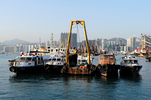 Boats moored at Hong Kong harbor in West Kowloon.