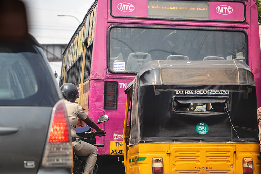 Chennai, India - October 8, 2023. Various forms of transportation wait at a stoplight in Tamil Nadu.
