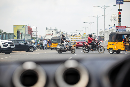 Chennai, India - October 8, 2023. Various forms of transportation wait at a stoplight in Tamil Nadu.