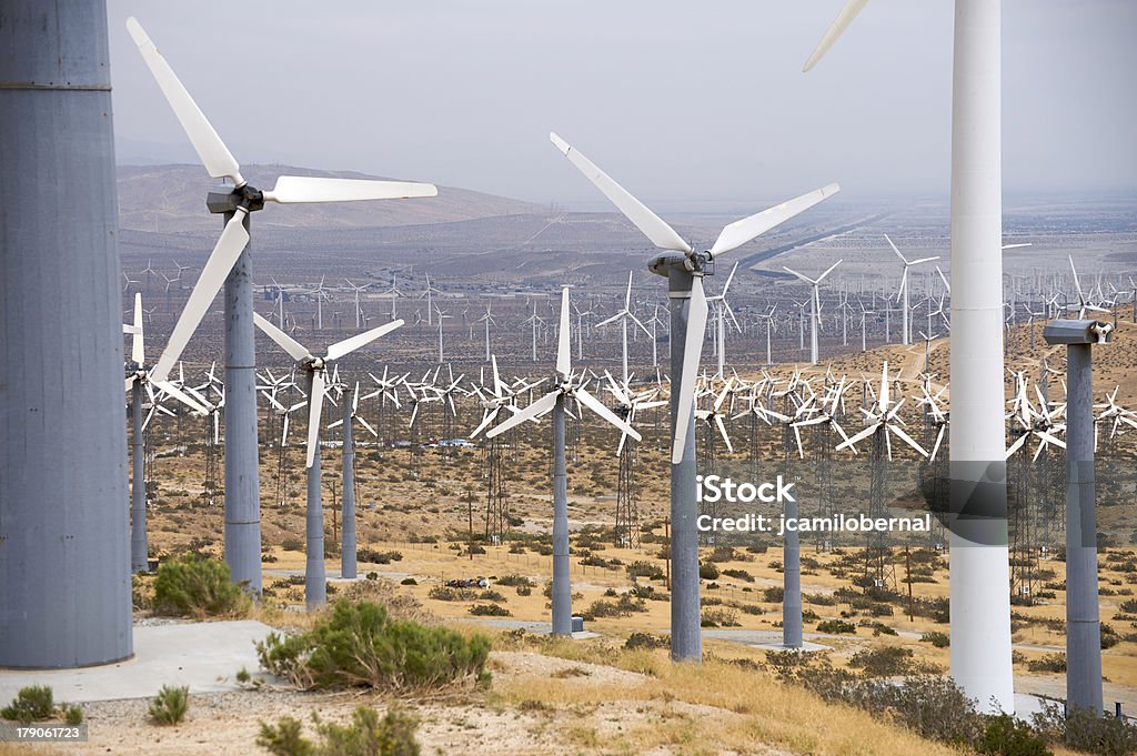 Wind turbines generating power "Lots and lots of wind turbines  generating alternative energy in Palm Springs, Southern California. A more ecological source of energy to generate electrical power and less petroleum." Heavy Industry Stock Photo