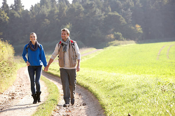 istock Young couple walking in park 179062347