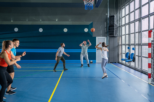 Young couple playing basketball.