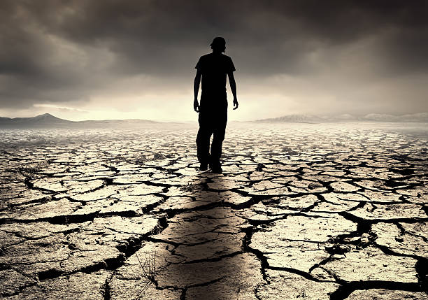 istock Silhouette of a man alone in a drought-ridden landscape 179062569