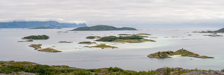 Beautiful small archipelago and shallow turquoise waters near the island of Sommarøa on a cloudy day, Tromsø Municipality in Troms og Finnmark county,  Northern Norway